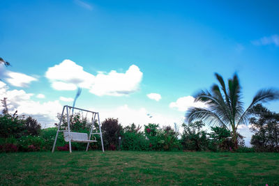 Scenic view of trees on field against sky