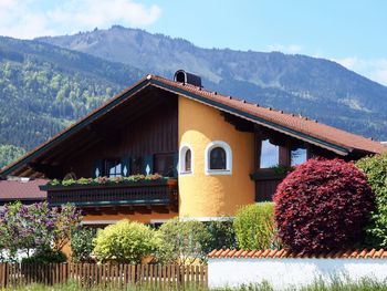 Built structure by house against sky