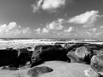 Rocks on beach against sky