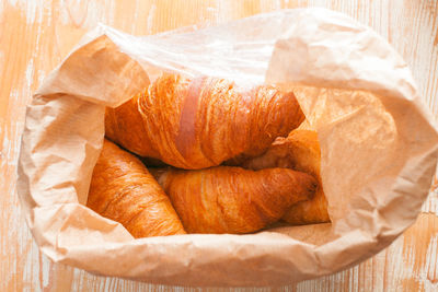 Croissants packed in brown paper bag