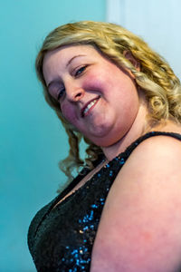 Portrait of smiling woman against gray background