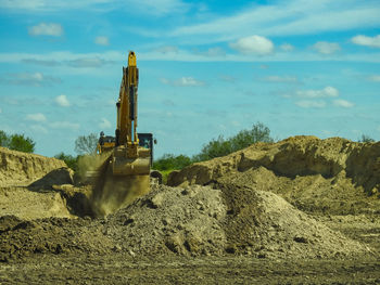Construction excavator digging a big hole
