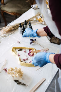 Midsection of man working on table