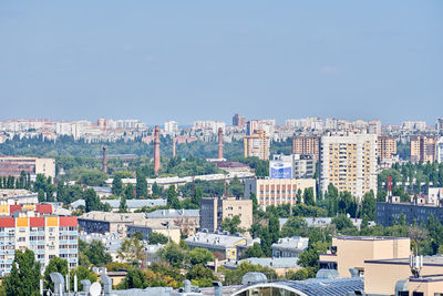 High angle view of buildings against clear blue sky