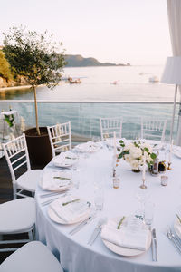 Table and chairs in restaurant by sea