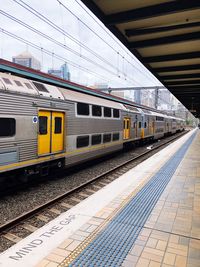 Train at railroad station in city