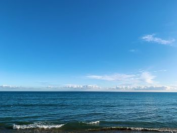 Scenic view of sea against blue sky