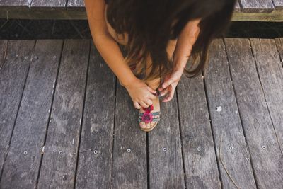 Low section of woman wearing sandal