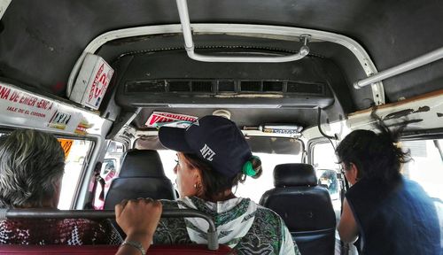 Rear view of man sitting in train