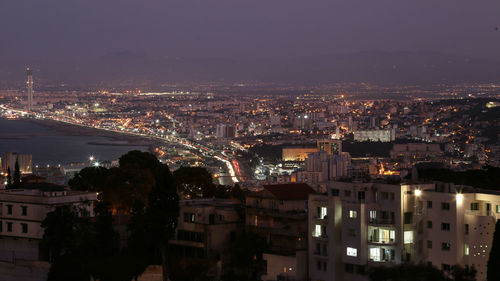 High angle view of illuminated buildings in city at night