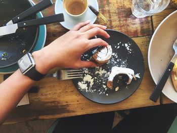 Cropped hand of woman holding dessert in plate