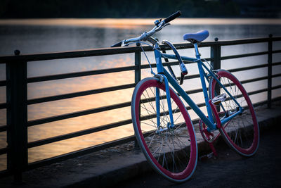 Close-up of bicycle parked by railing