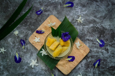 High angle view of purple and fruits on table