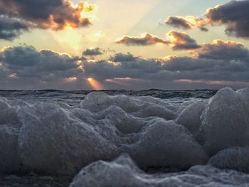 Scenic view of sea against cloudy sky