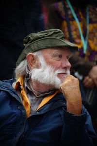 Portrait of man wearing hat looking away outdoors