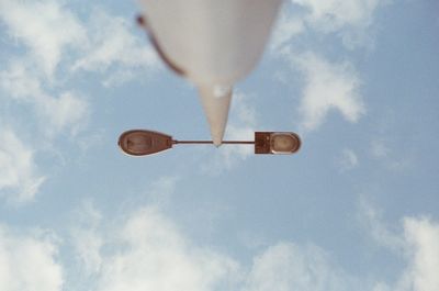 Low section of person paragliding against sky