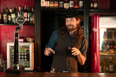 Full length of young man standing in restaurant