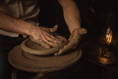 Man makes plate in pottery workshop, clay product, authentic atmosphere, background, 