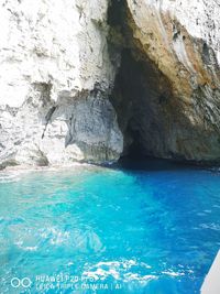 Scenic view of sea seen through cave