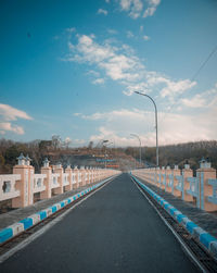 Empty road against blue sky