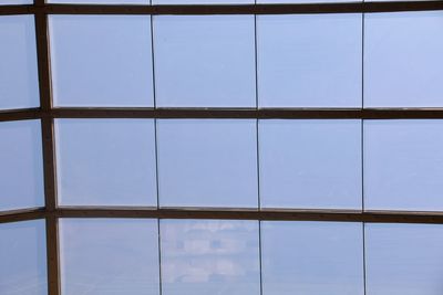 Low angle view of sky seen through glass window