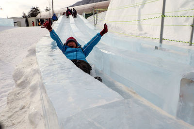 Person enjoying on slide at yongpyong ski resort during winter