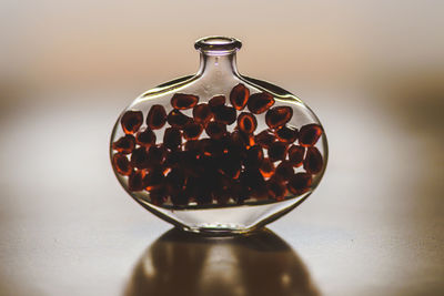 Close-up of pomegranate seeds in glass on table