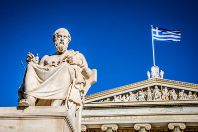 Low angle view of statue against clear blue sky