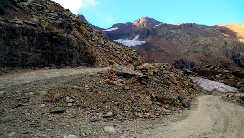 View of rocky landscape against mountain range