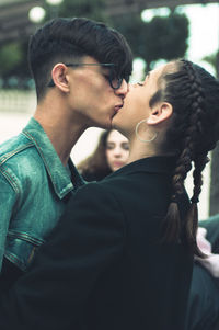 Close-up of couple kissing while standing outdoors