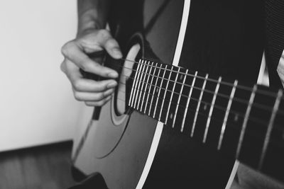 Close-up of man playing guitar