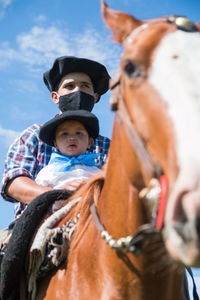 Portrait of boy riding horse