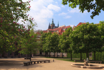 Statue amidst trees at temple against sky