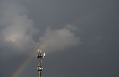 Low angle view of communications tower against sky