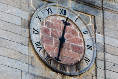 Close-up of clock on brick wall