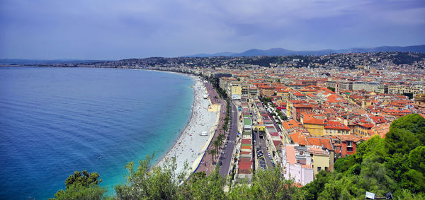 High angle view of townscape by sea against sky