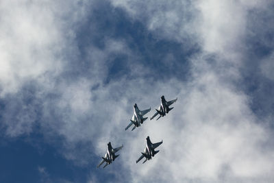 Low angle view of airshow against sky