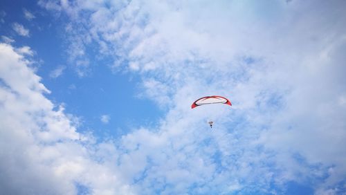 Low angle view of paraglider against sky