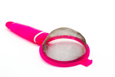 Close-up of pink toy over white background