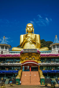 Low angle view of statue against sky