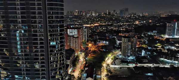 High angle view of illuminated buildings in city at night