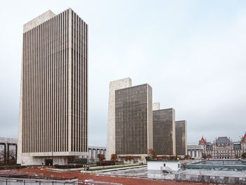 Modern buildings in city against sky