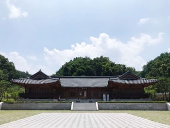 Exterior of building by trees against sky