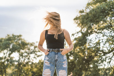 Rear view of woman standing against sky