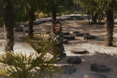 Portrait of young woman sitting outdoors