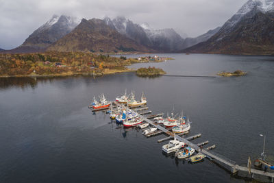 Boats docked in port in lofoten fjords from drone view