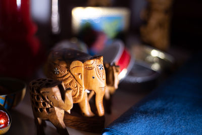 Close-up of elephant figurines on table at home