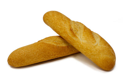 Close-up of bread in plate against white background