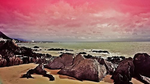 Scenic view of sea against cloudy sky