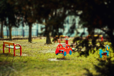 Red toy car on field in park